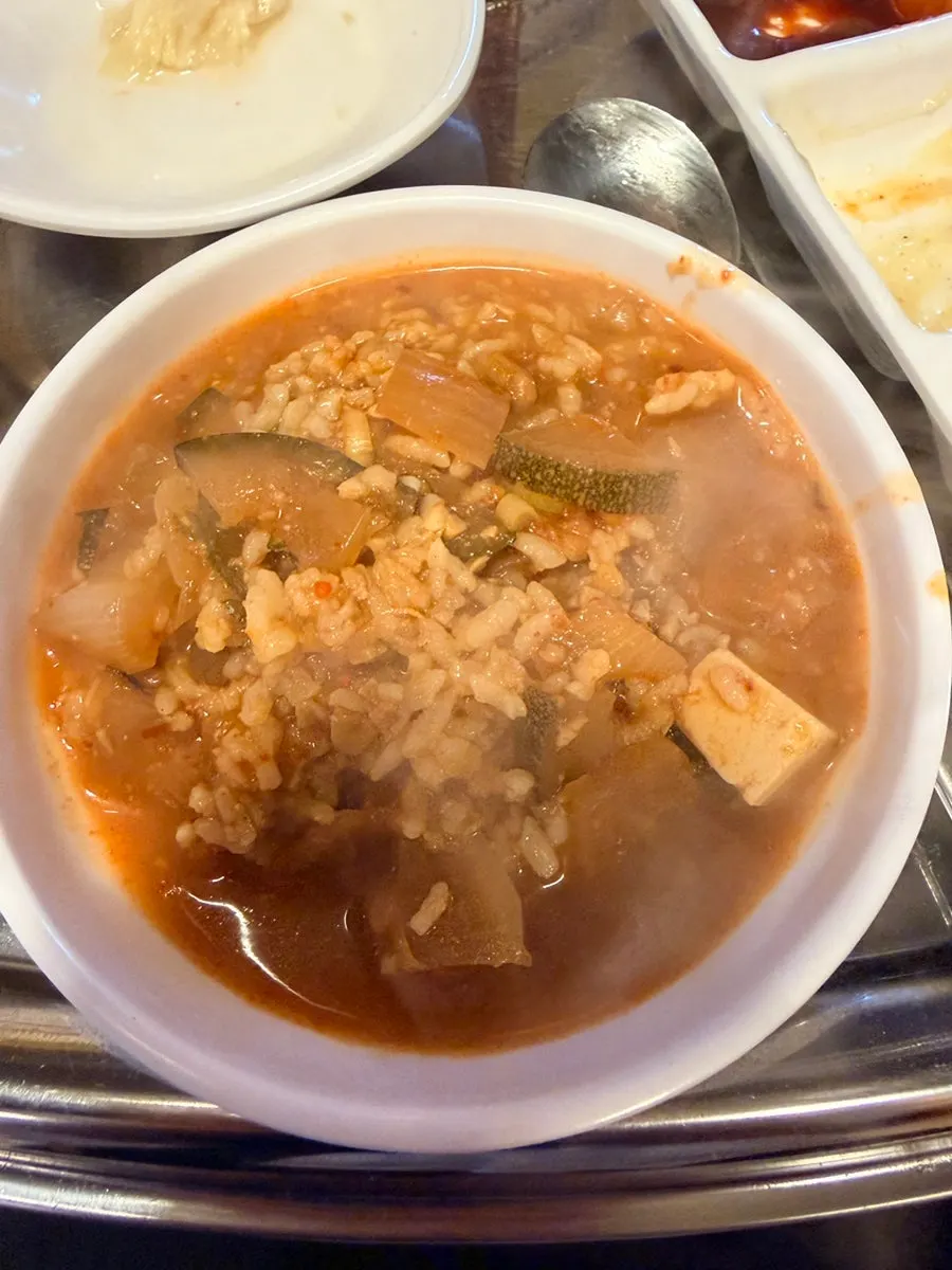Grandma's doenjang rice soup in a large earthenware pot