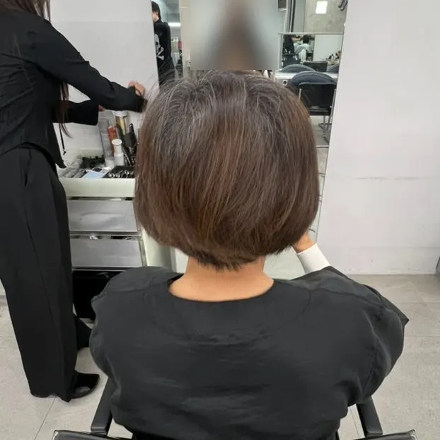 Hair with a gapped part before the root perm