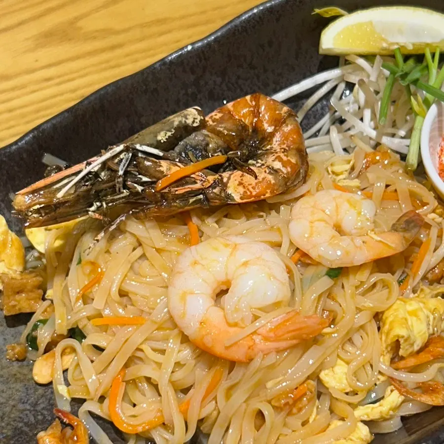 Pad thai noodles picked up together with a prawn