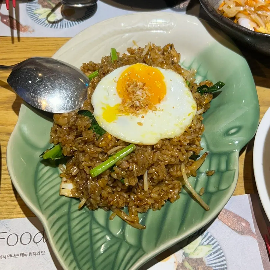 A plate of nasi goreng topped with egg