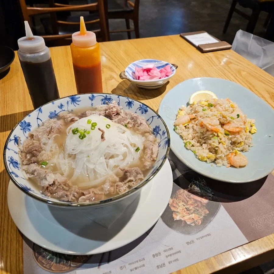 Table setting with Vietnamese pho and shrimp crab fried rice