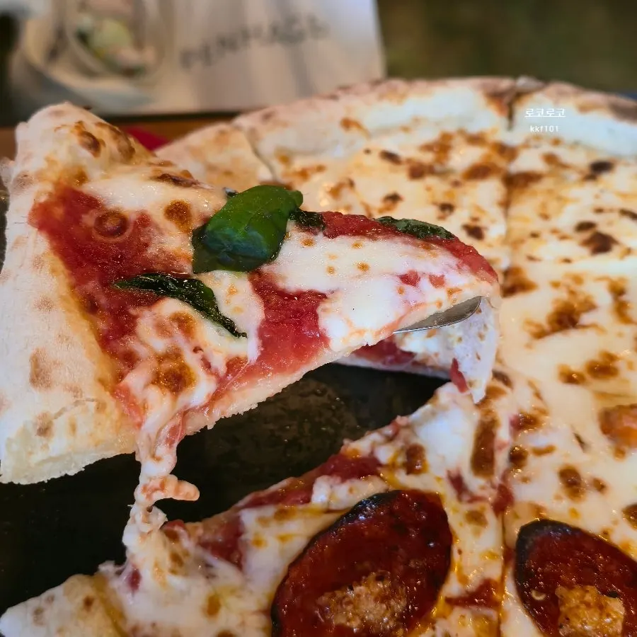 Wood-fired pizza showing the Margherita and Diavola sections