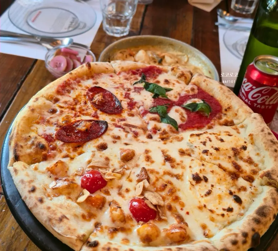 Slice of Quattro Stagioni pizza good for sharing four flavors