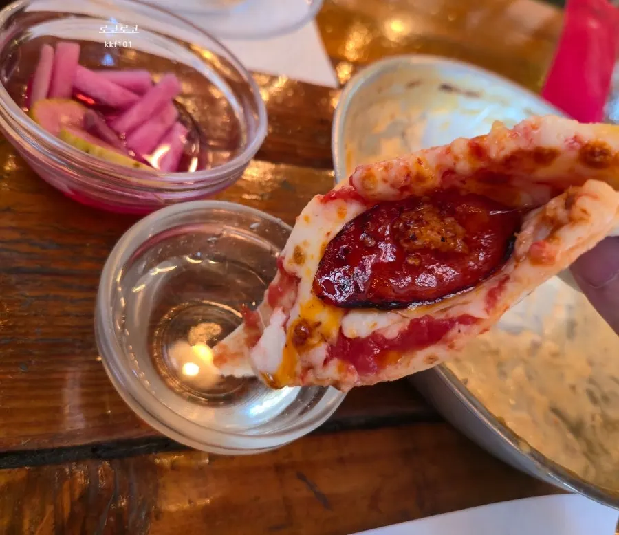 Cheese stretching from a slice of wood-fired pizza