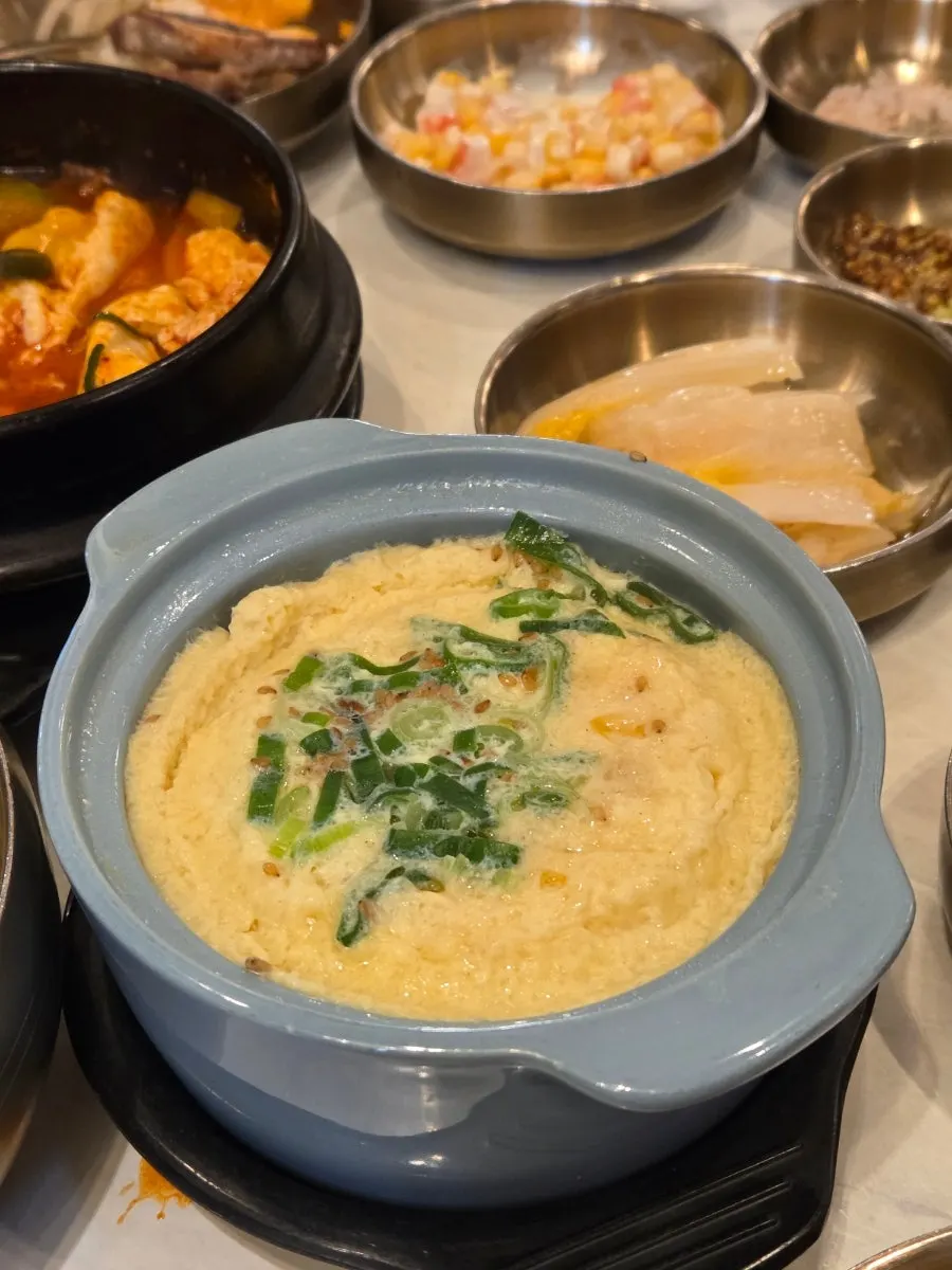 Steamed egg served in a sky-blue flower-shaped bowl