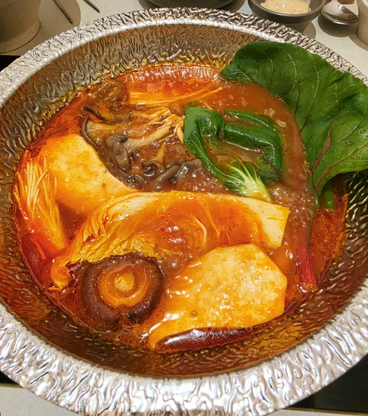 Shabu-shabu table setting with beef tomato broth at Shabu in Seoul Hapjeong Branch