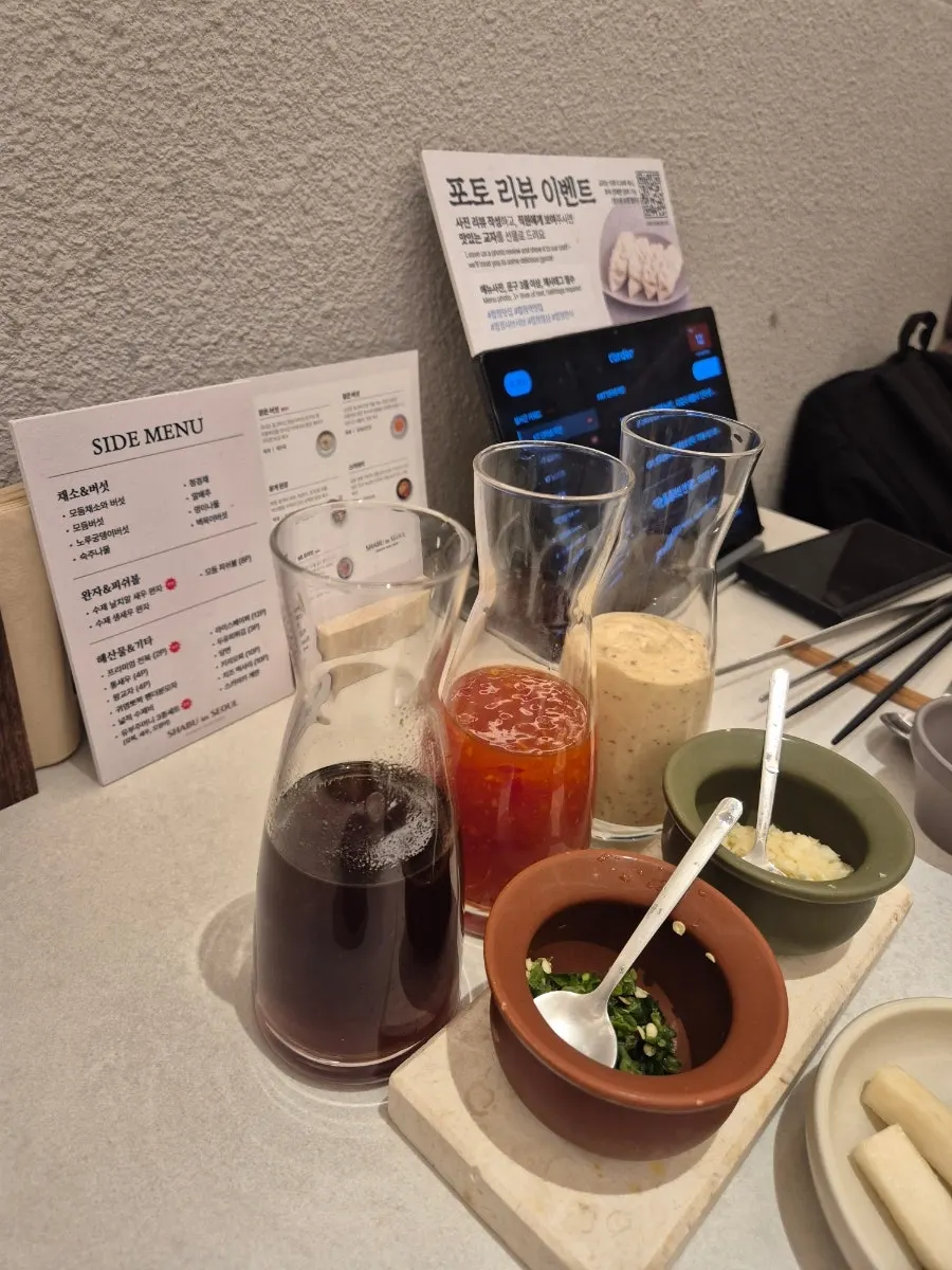Three shabu-shabu sauces served in clear bottles