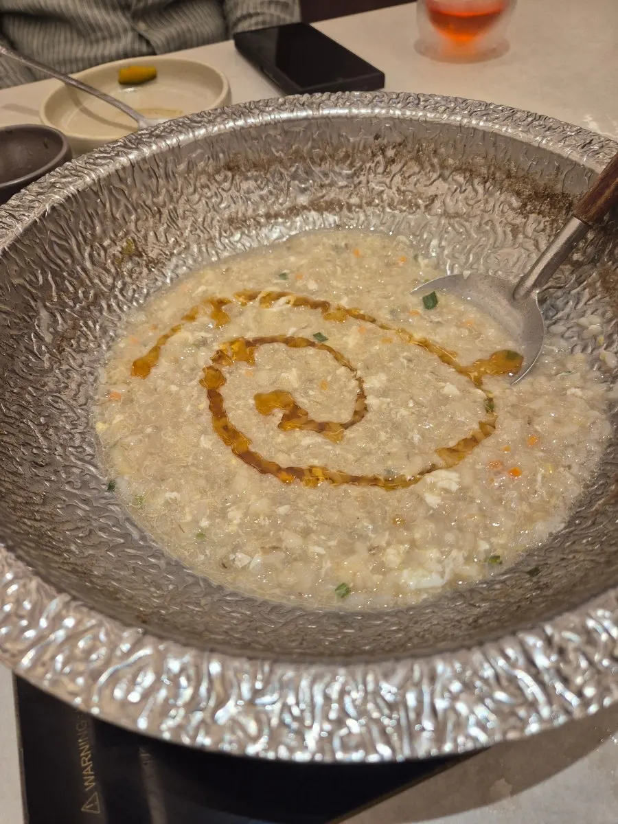 Egg porridge topped with seaweed flakes and sesame oil
