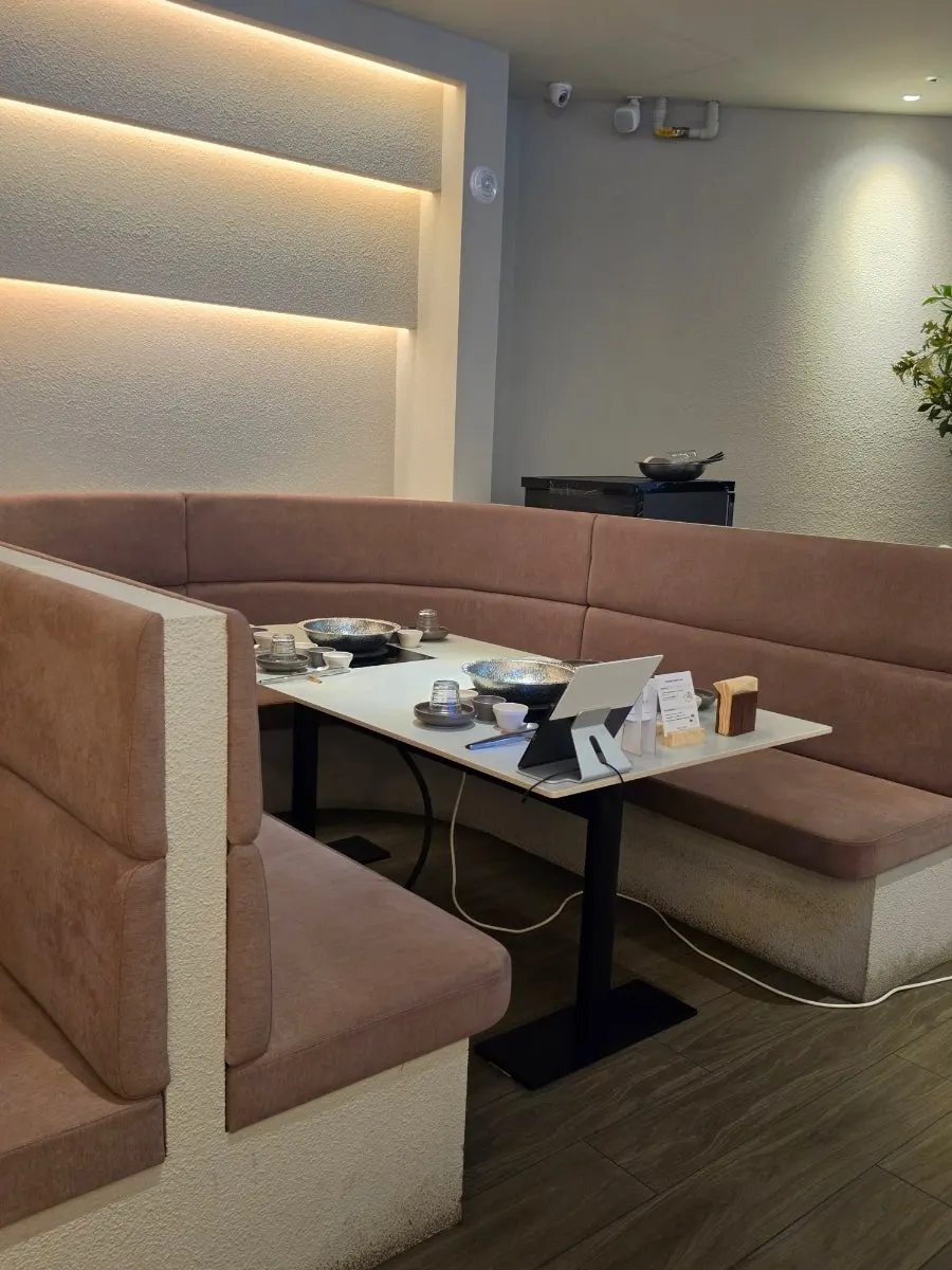 Interior of Shabu in Seoul Hapjeong Branch in white and wood tones