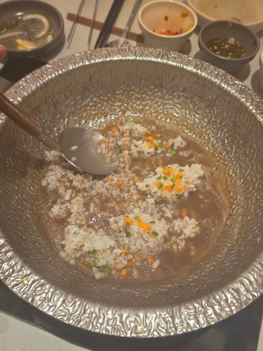 Dipping the rice paper wrap into sesame sauce