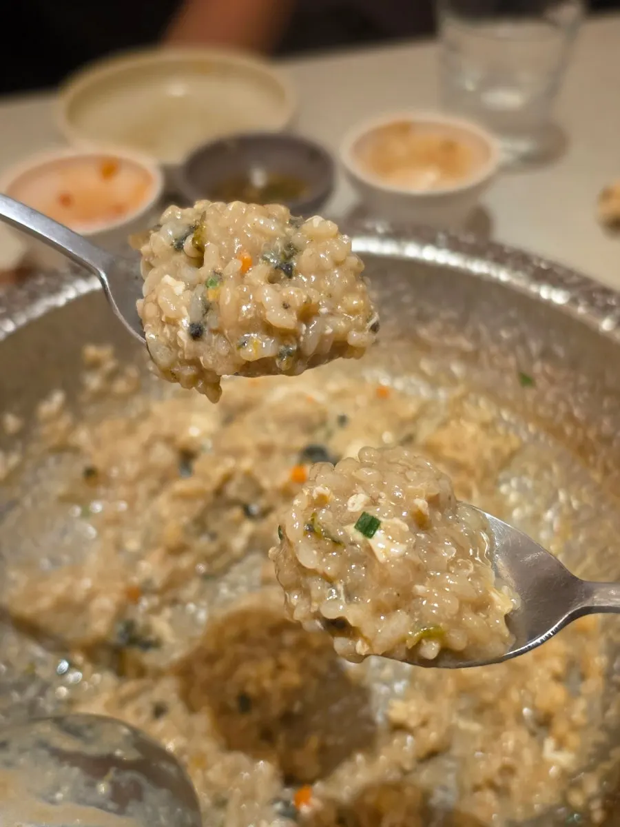 Egg porridge topped with pepper, sesame oil, and seaweed flakes