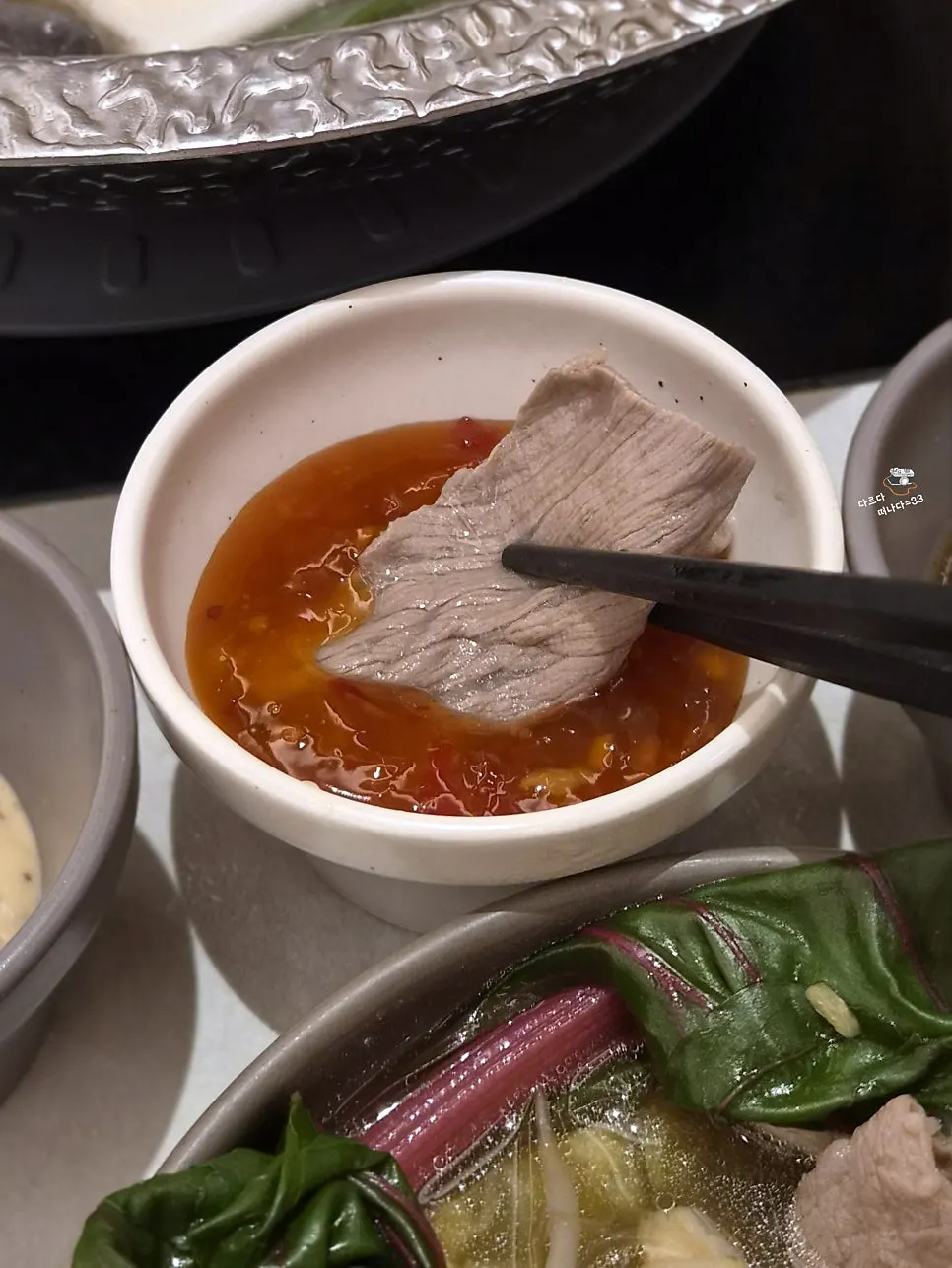 Picking up meat with personal tongs
