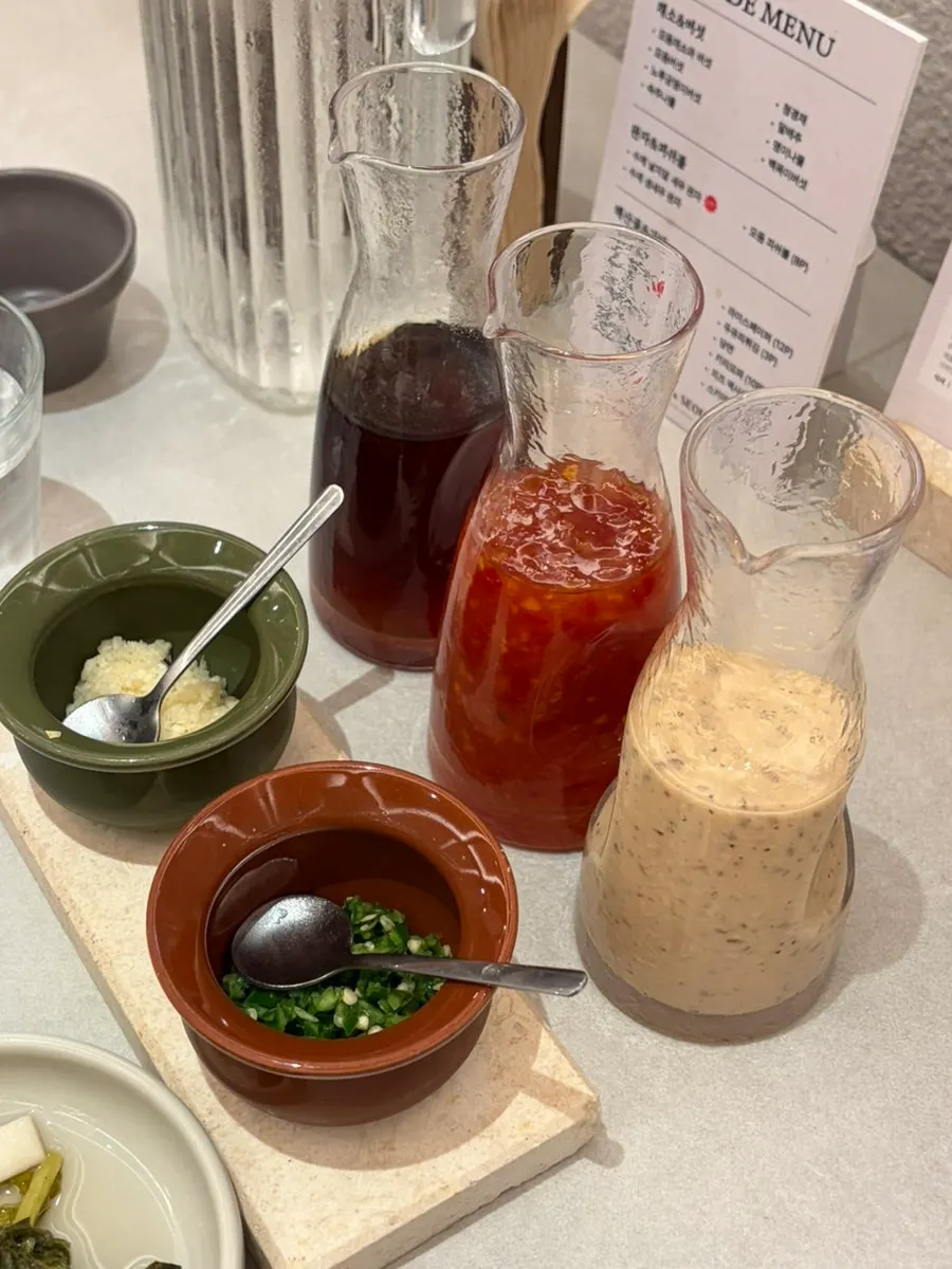 Three sauces: sesame sauce, chili sauce, and sesame paste sauce