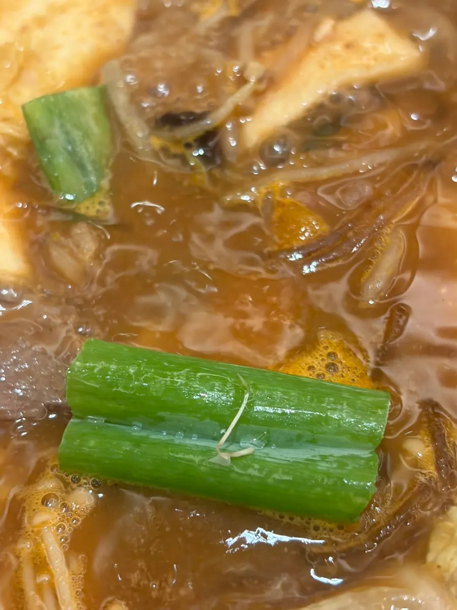 Vegetables and meat simmering in the boiling blue crab miso broth