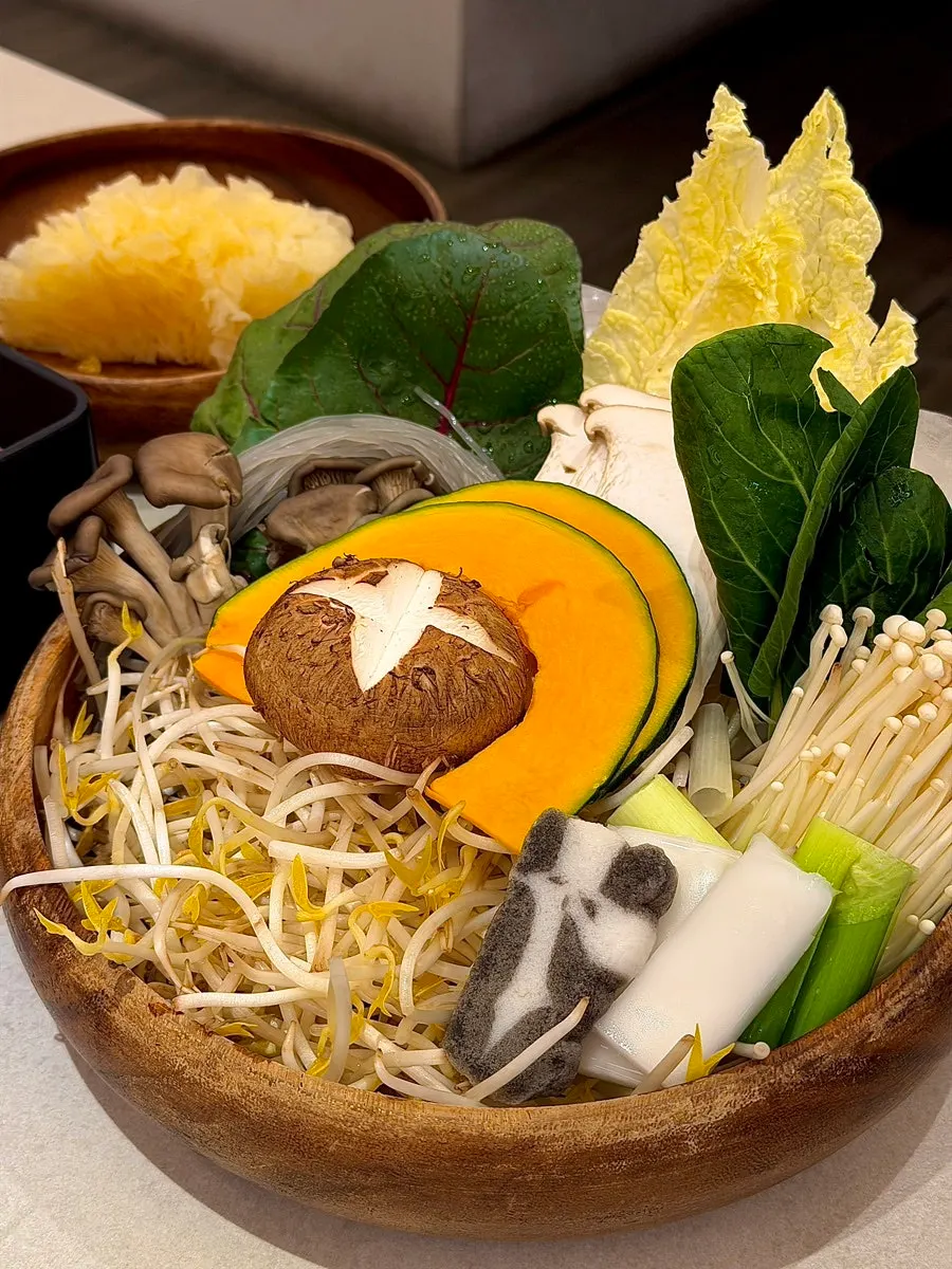 Wood bowl filled with vegetables and mushrooms