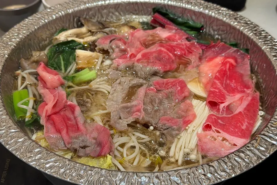 Clear mushroom broth boiling with mushrooms and vegetables