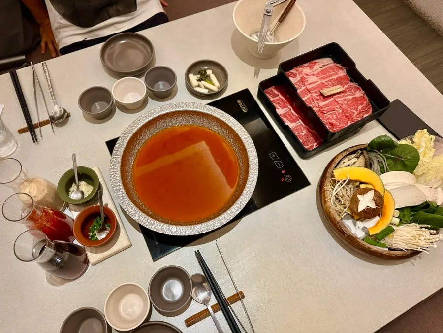 Table fully set with shabu-shabu dishes