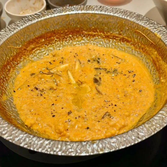 Tray of rose risotto ingredients being cooked by staff