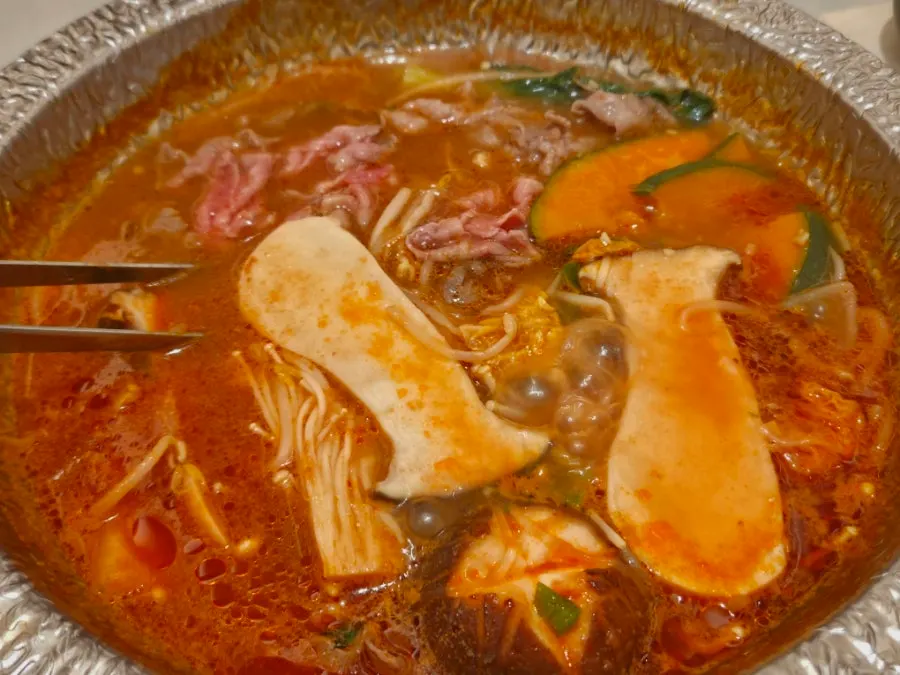 Meat and vegetables cooking in beef tomato broth