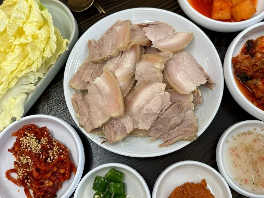 보쌈과 곁들이 반찬이 놓인 테이블