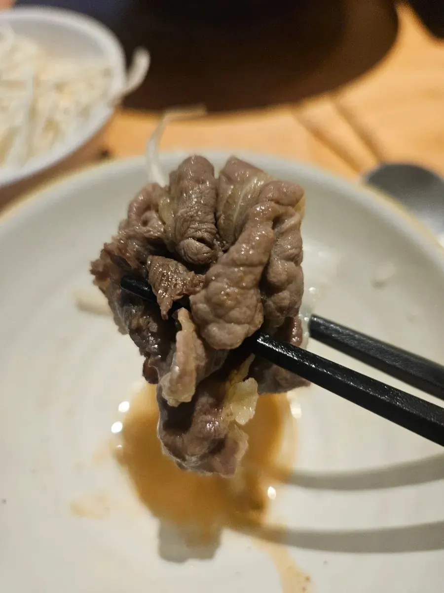 A piece of clear-broth shabu-shabu meat