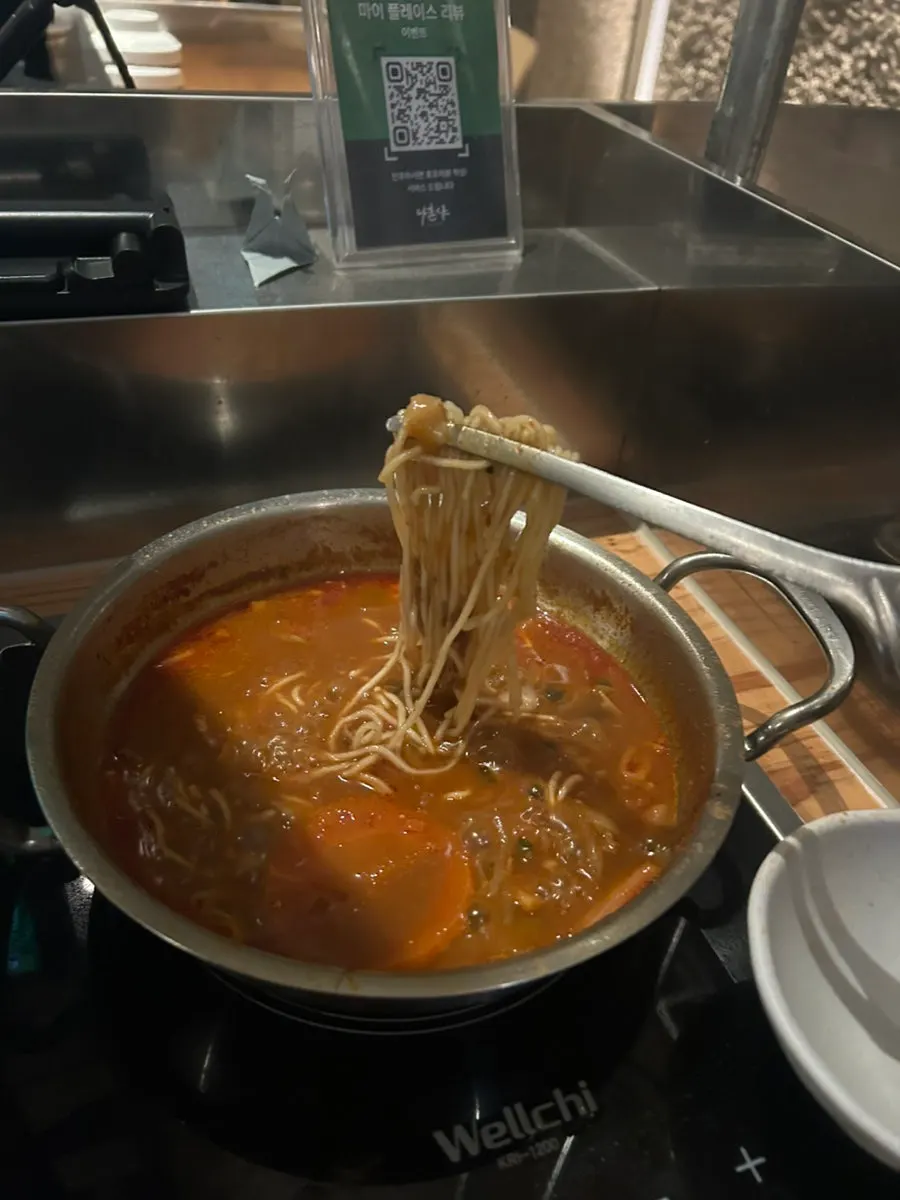 Fresh noodles cooking in broth