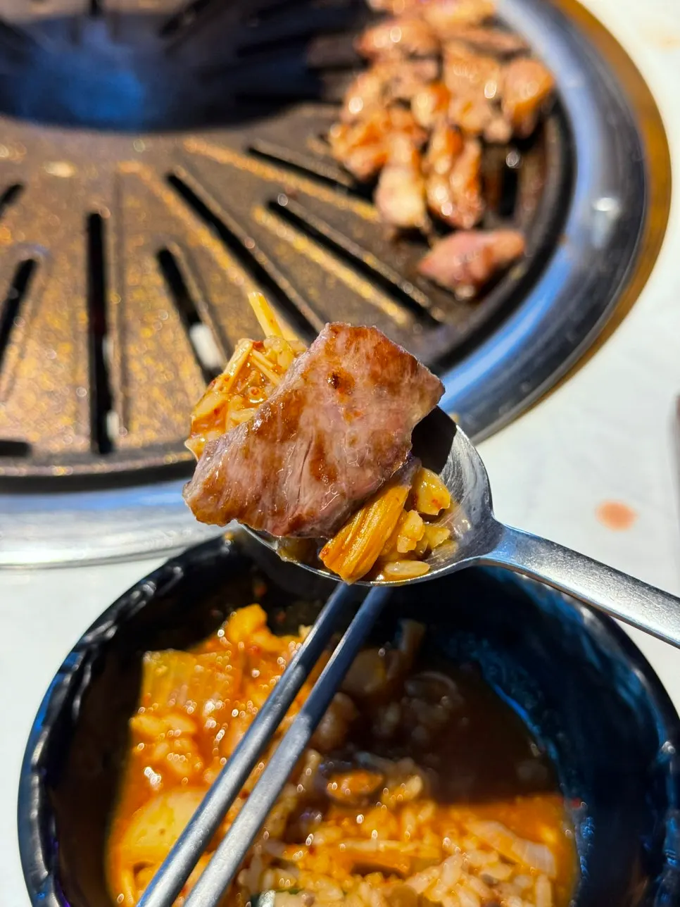 Vertical shot of meat, rice soup, and steamed egg together