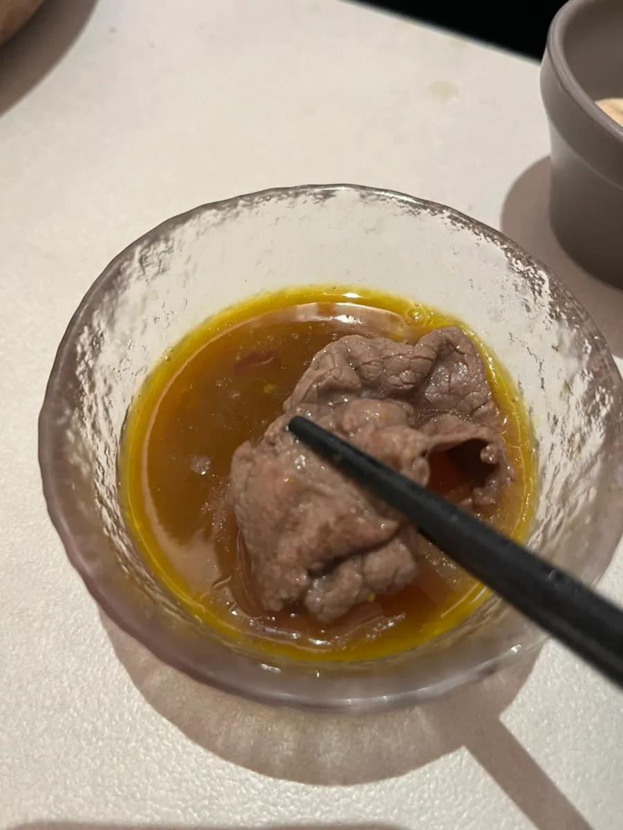 Sukiyaki broth served with egg