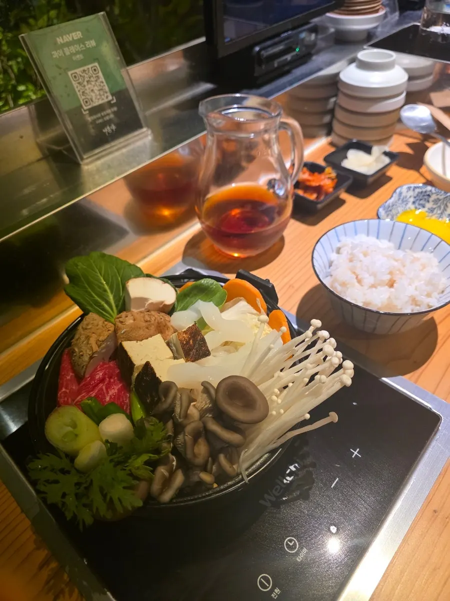 Pot of Hon Special Sukiyaki filled with vegetables, mushrooms, and meat