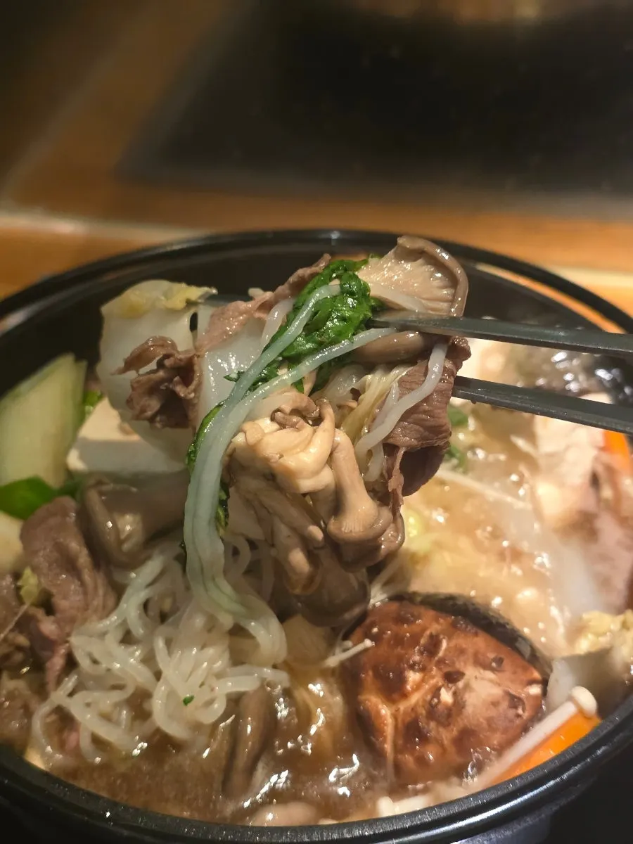 A piece of sukiyaki meat dipped in egg