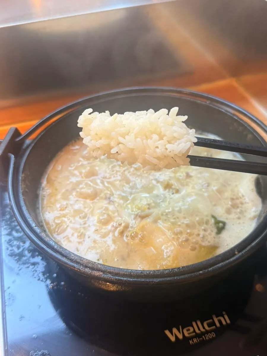 Finishing the meal with egg and rice added to the leftover broth