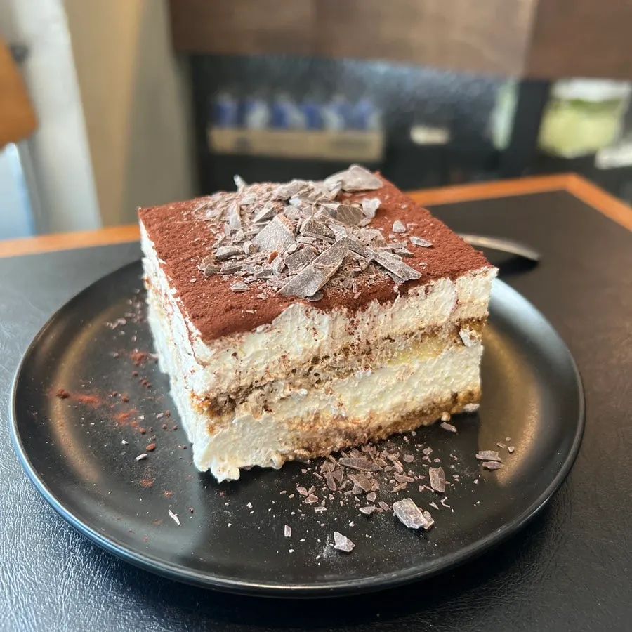 Cross-section of classic tiramisu topped with dark chocolate