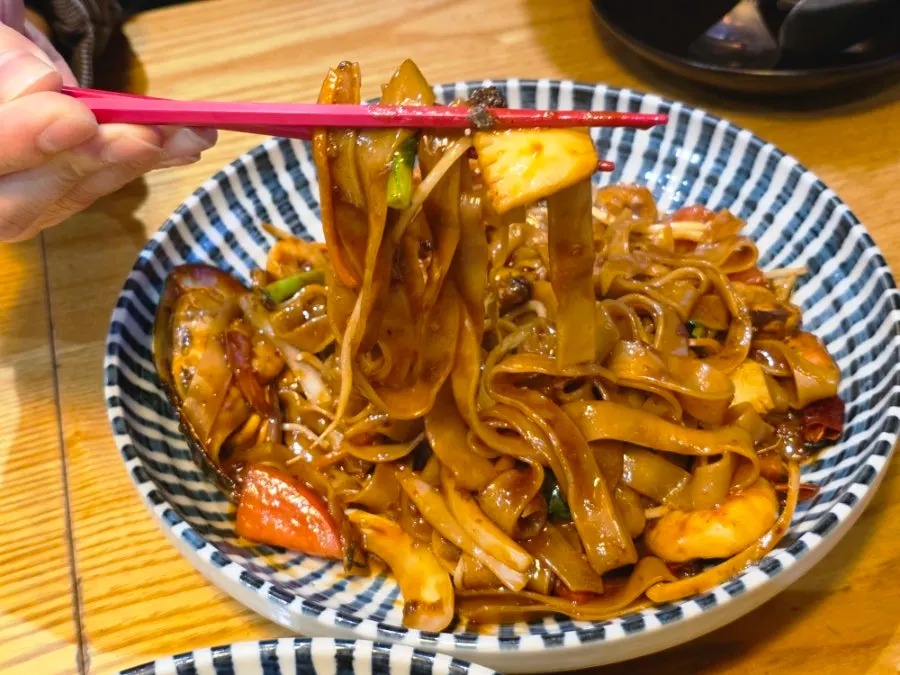 Thai chili noodles showing thick noodles and crunchy vegetables