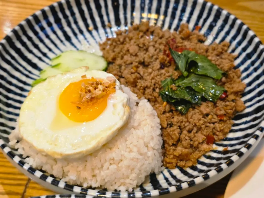 Basil pork stir-fry served with fried egg rice