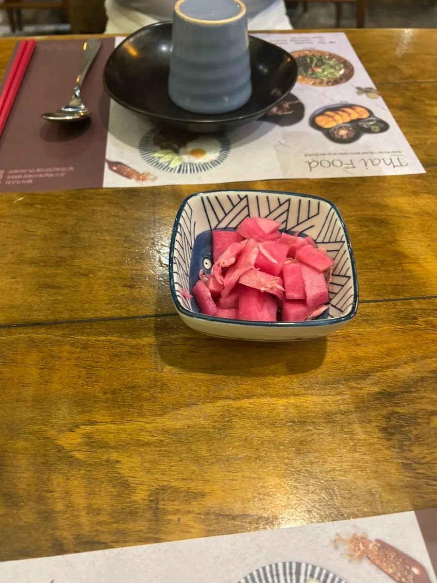 Pickled radish and utensils set on the table