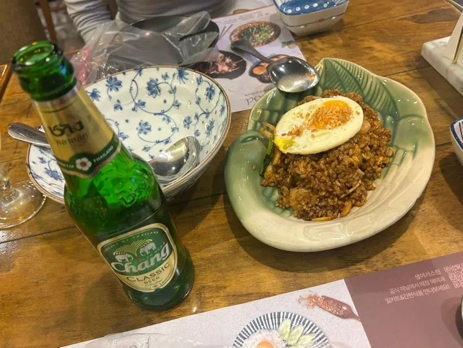 Table set with Chang beer and Thai dishes