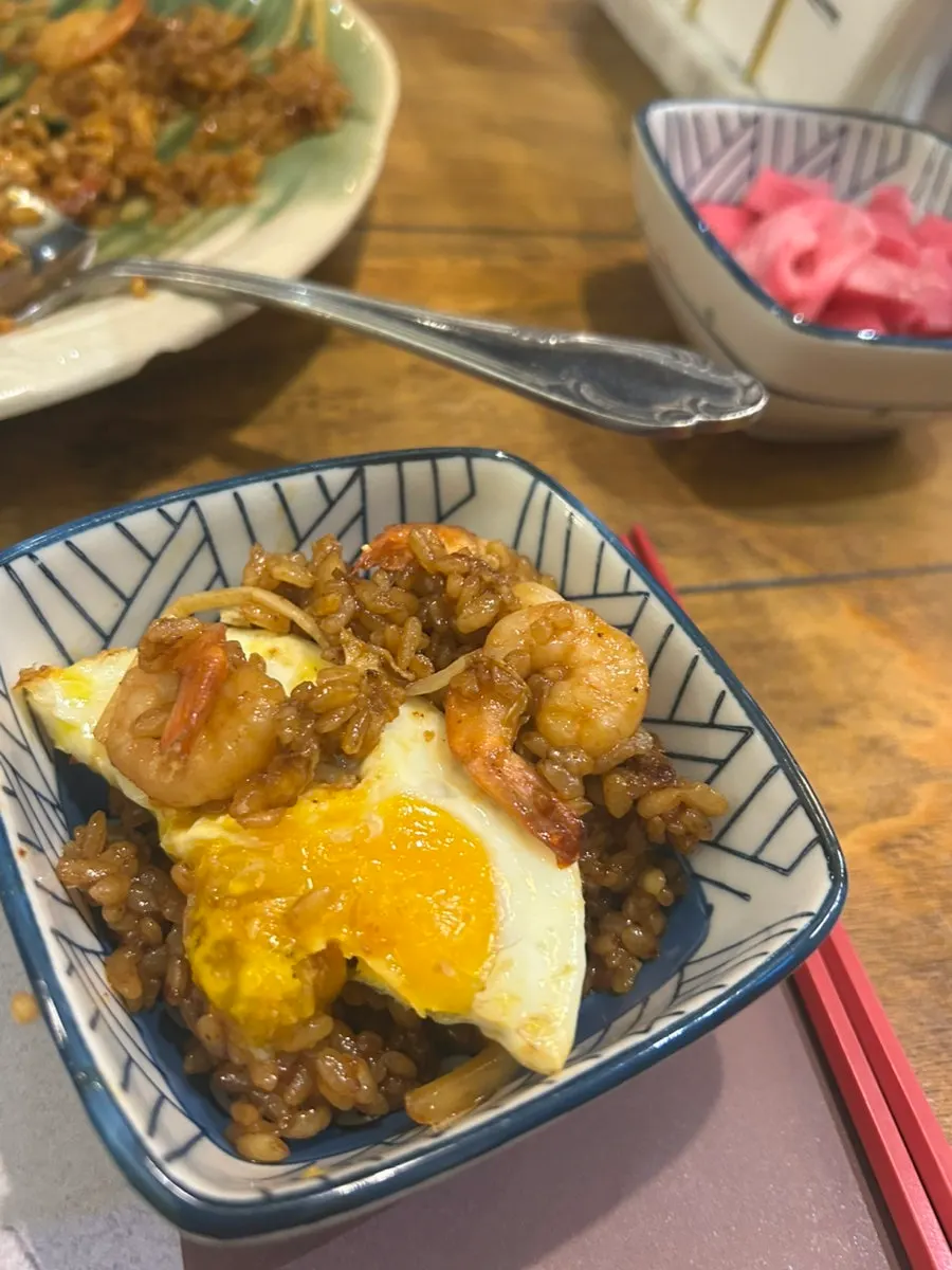 A plate of nasi goreng topped with a fried egg