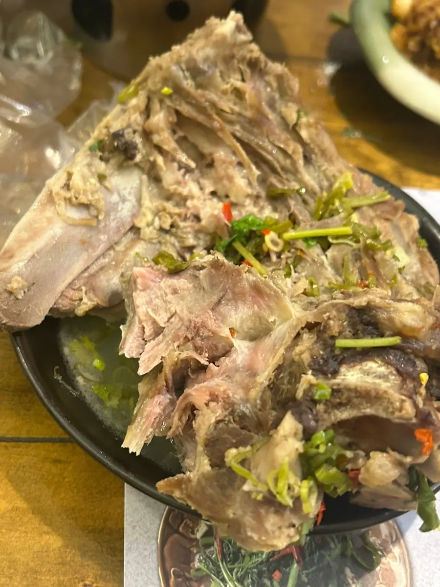 A piece of leng saap meat being picked up