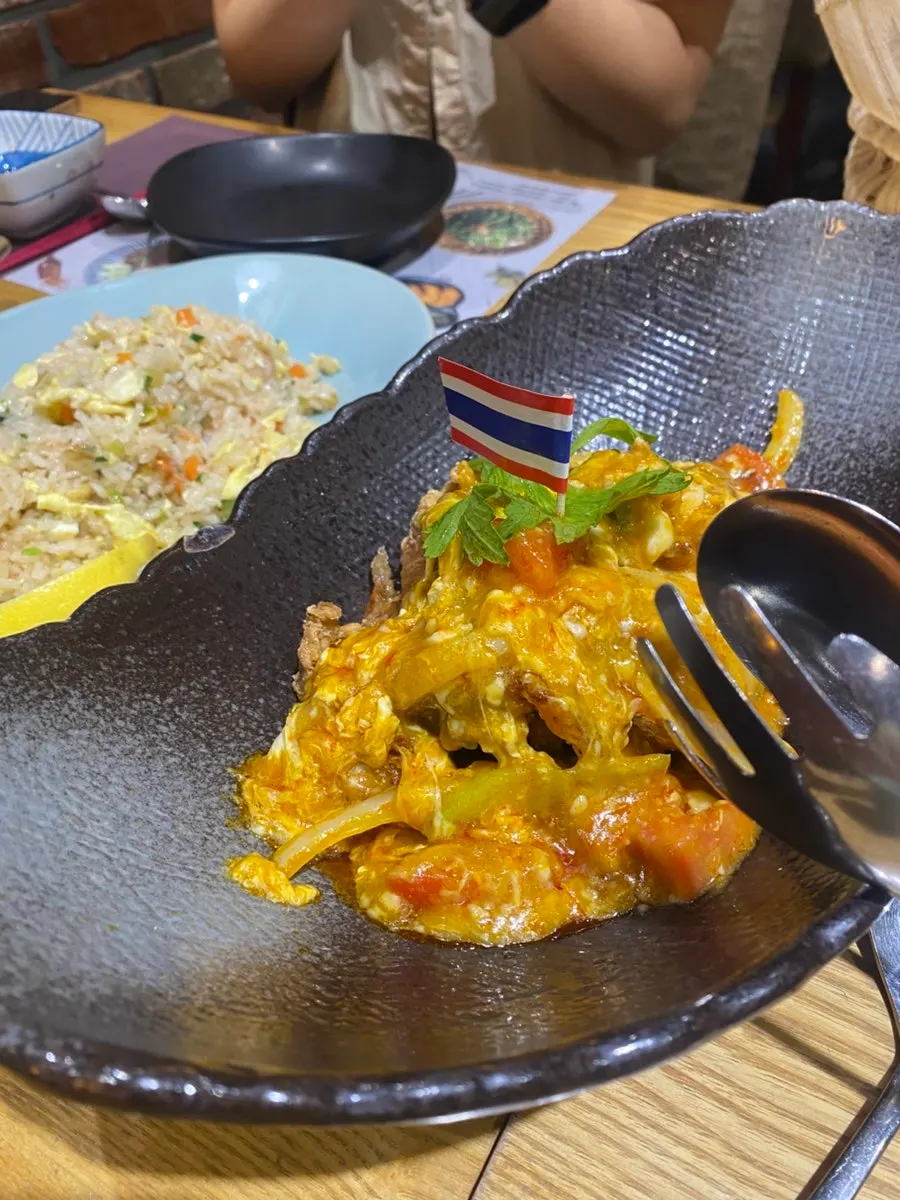 A table spread with several Thai dishes