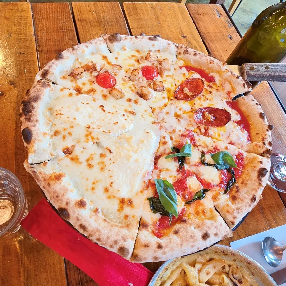 Four-flavor Quattro Stagioni pizza on a tray