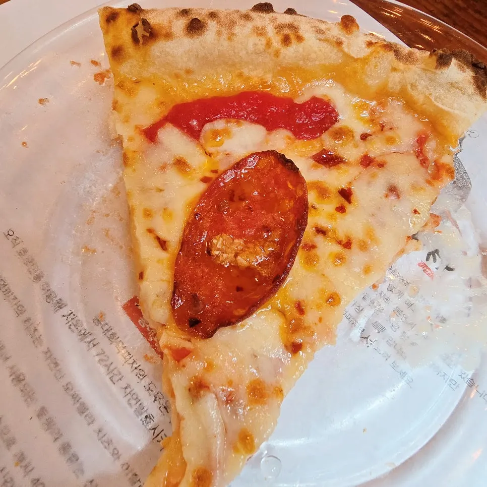 Cross-section of pizza crust baked in the wood-fired oven