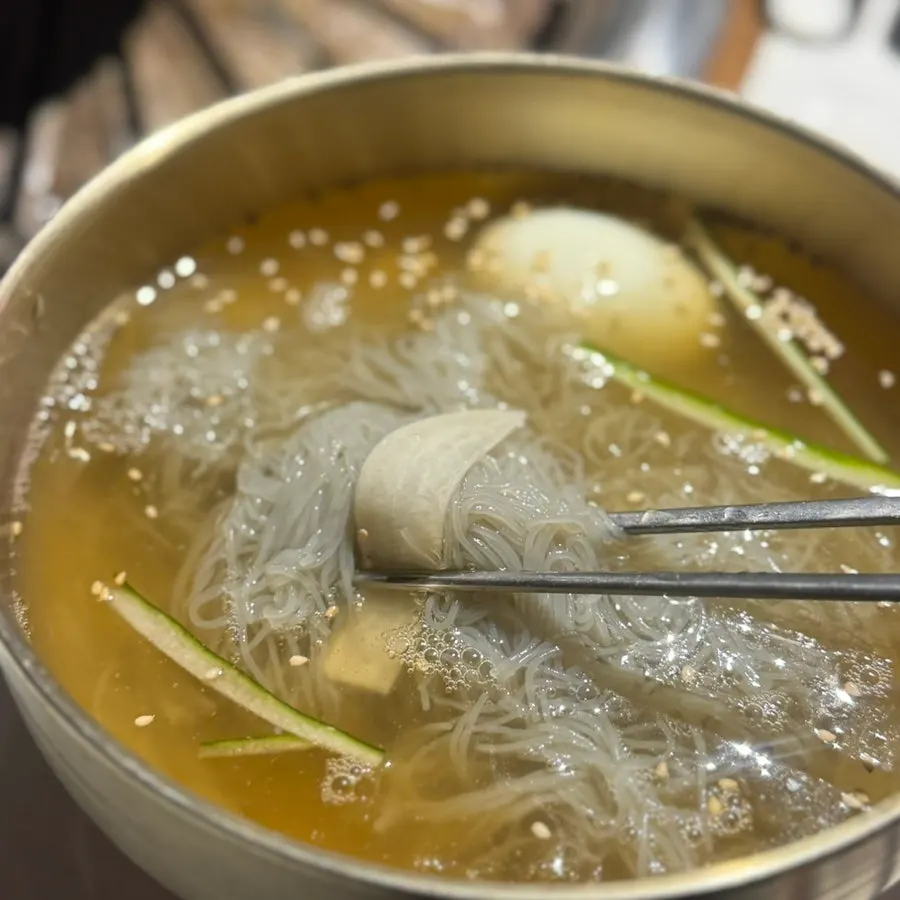 Water naengmyeon topped with cucumber, radish, and egg