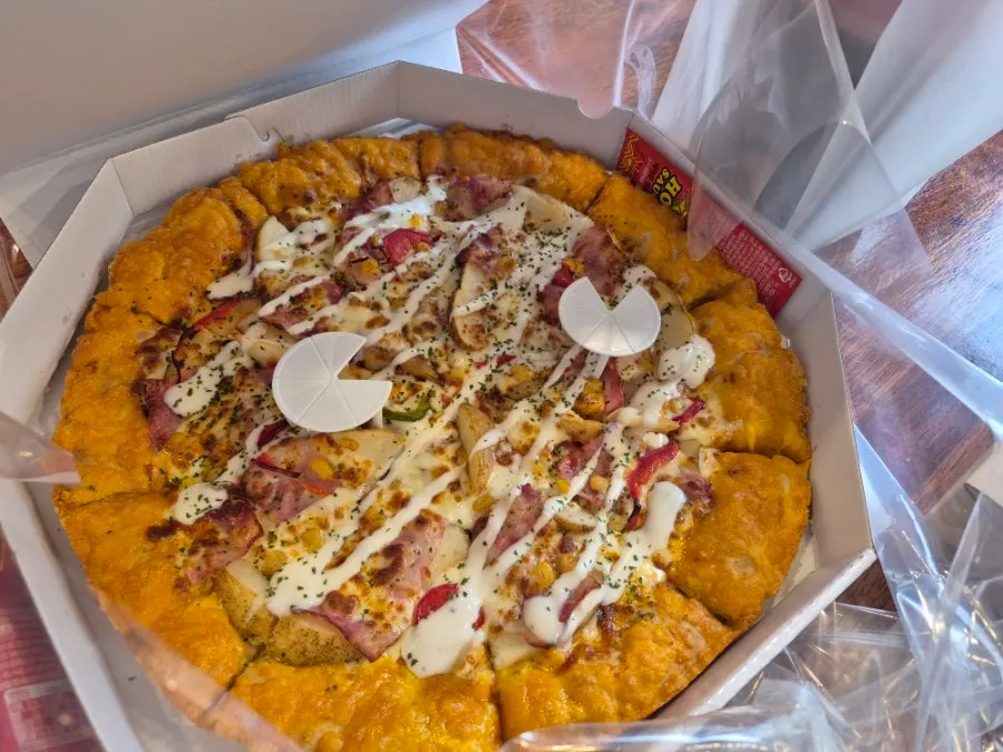 Pizza slice with a big chunk of potato on top