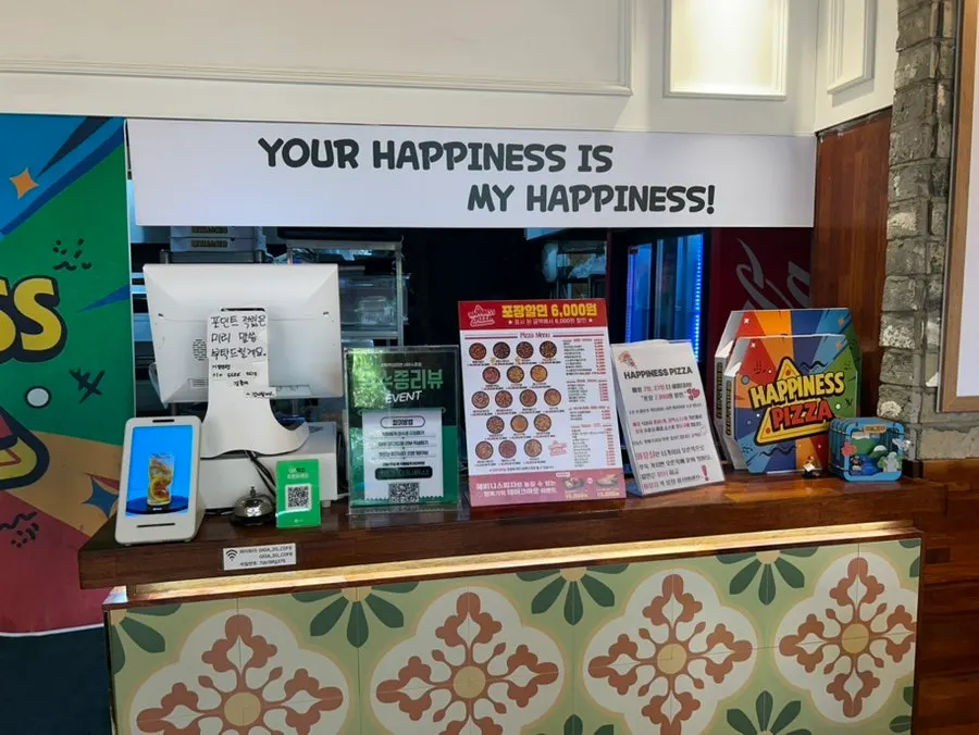 Interior near the order counter at Happiness Pizza