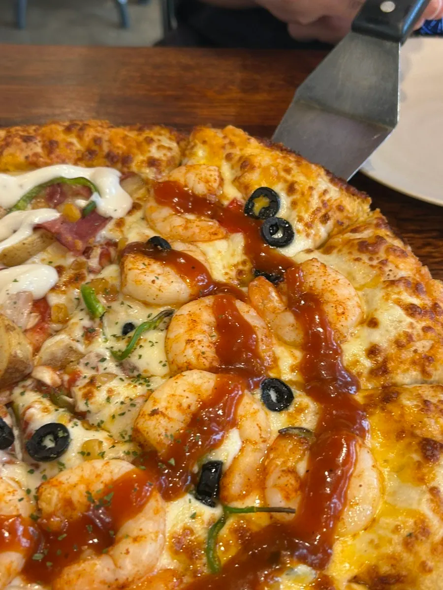 A whole half-and-half pizza on the table