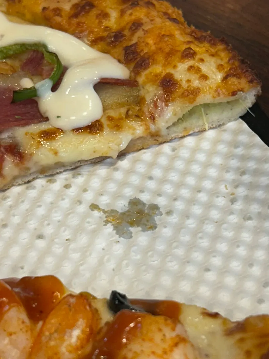 A pizza slice loaded with bacon and potato