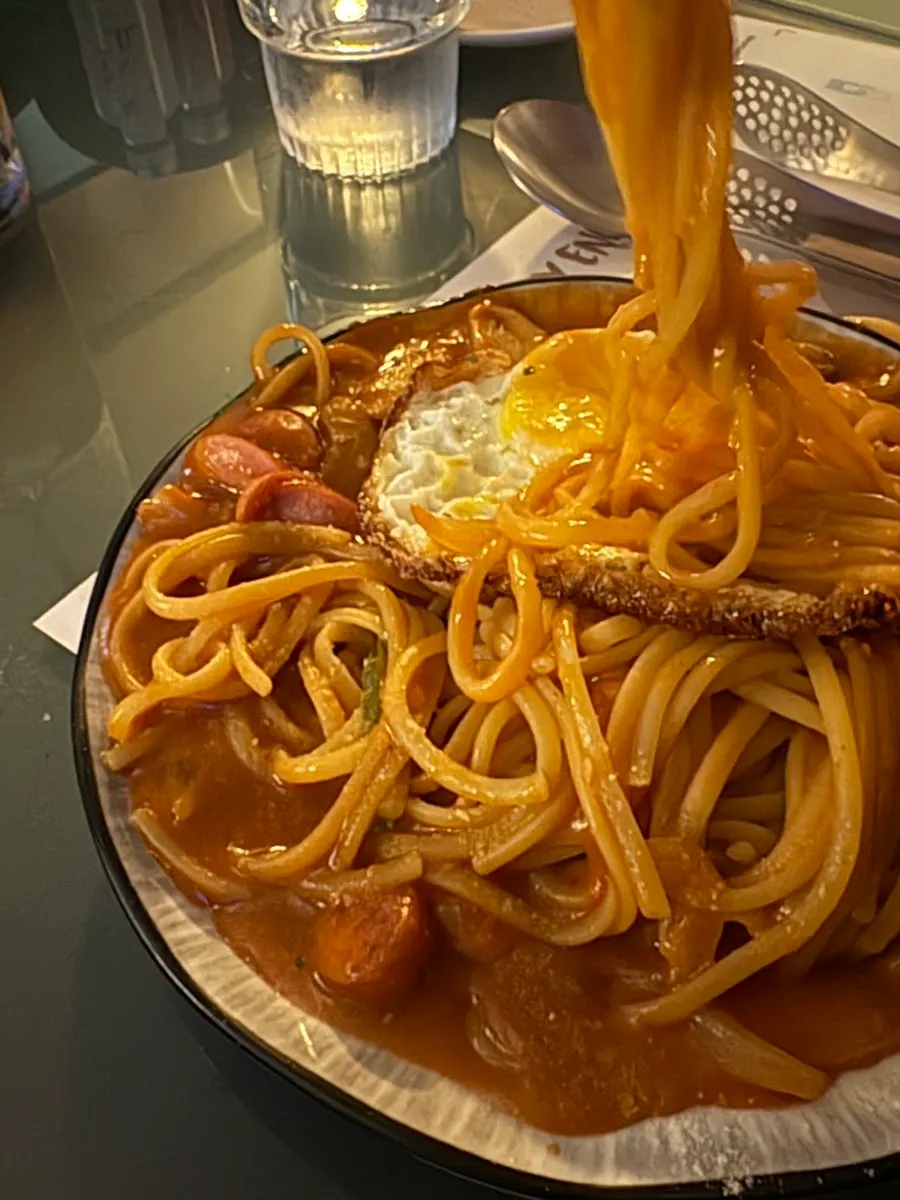 Napolitan pasta mixed with a broken egg yolk