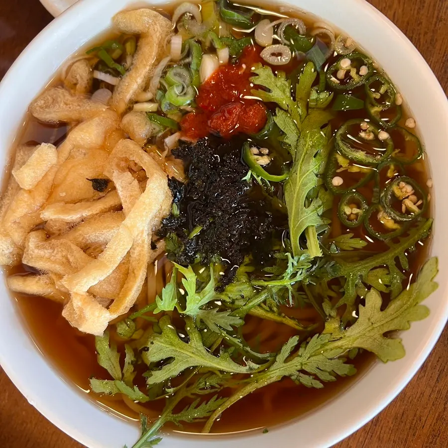 Spicy udon topped with ssukgat, cheongyang chili, and dadaegi