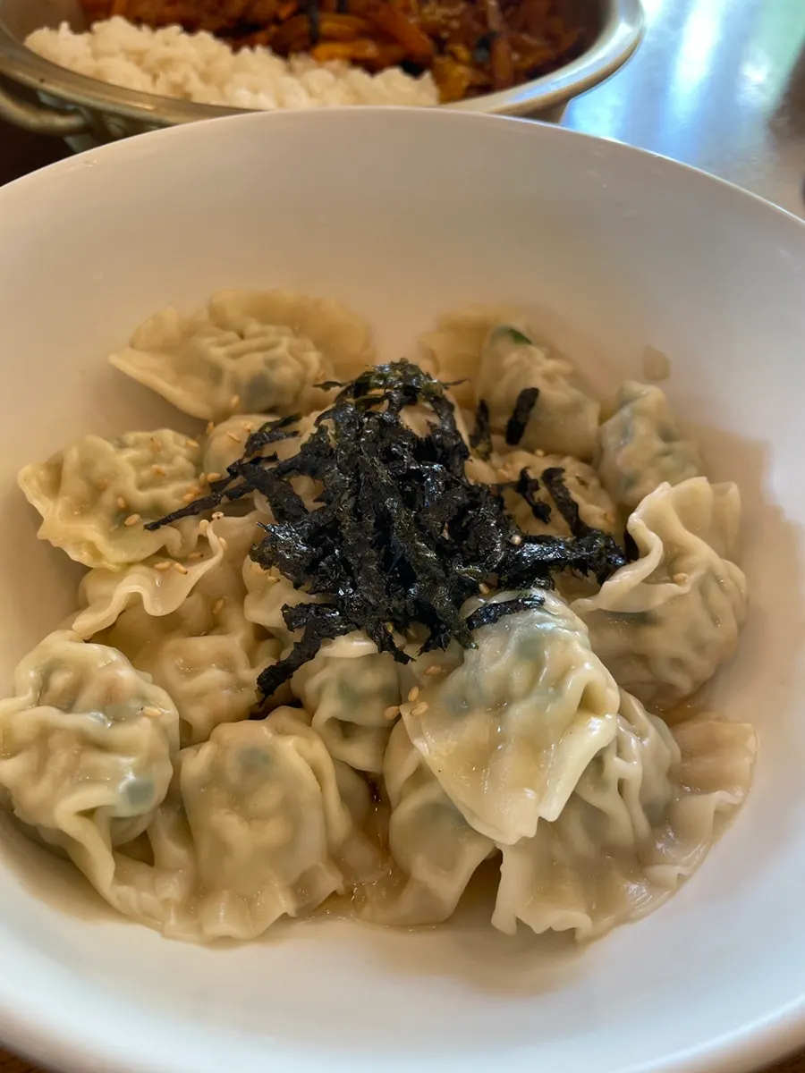 Bite-sized mandu dipped in soy sauce