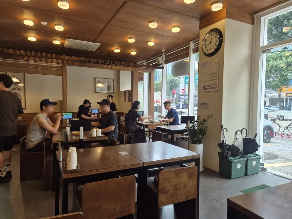 Interior of the restaurant with udon, rice bowls, and pork cutlet listed on the wall